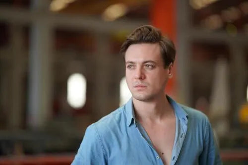 files/portrait-of-handsome-man-on-blue-shirt-standing-at-outdoor-photo.webp